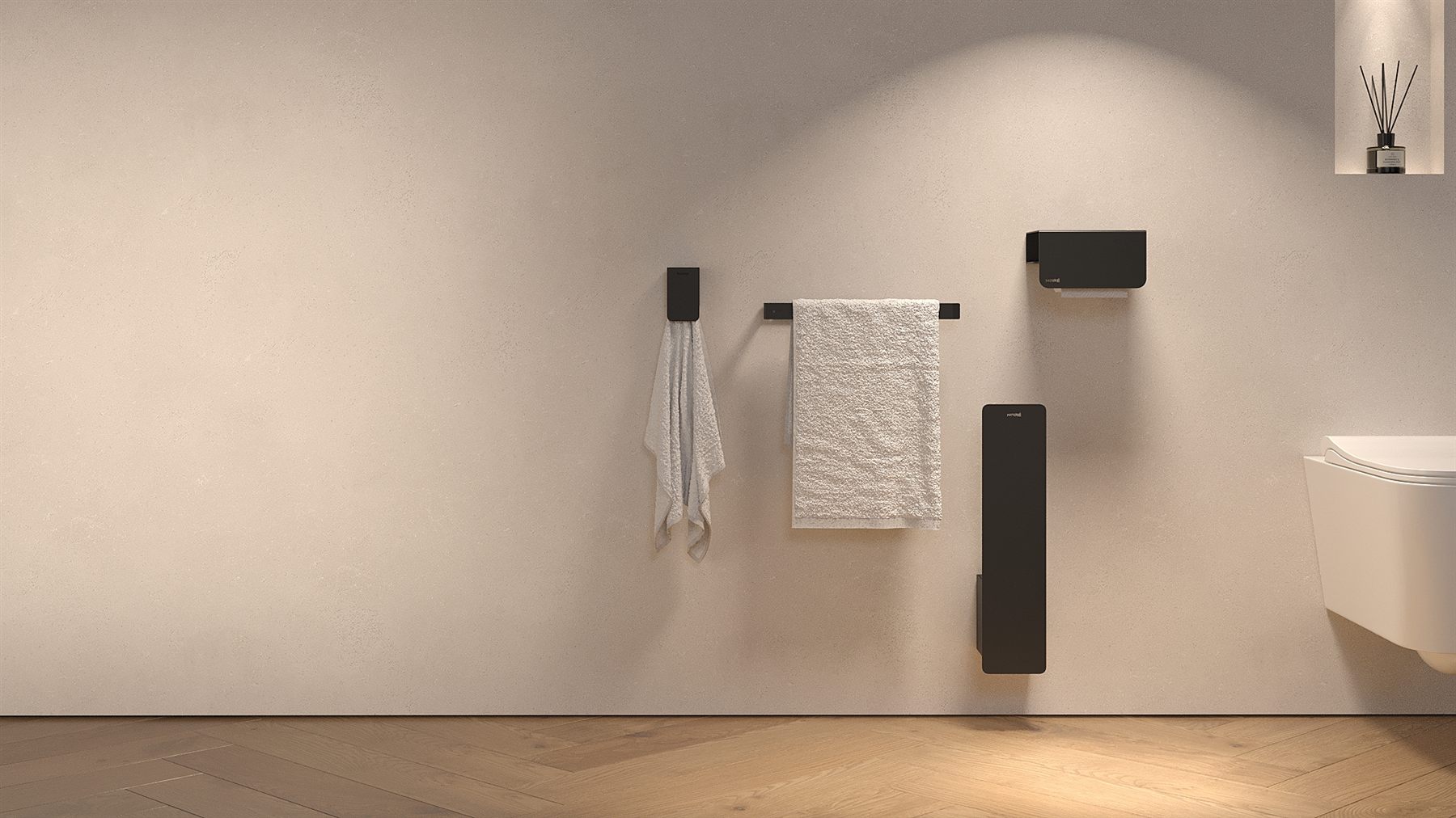 Noiré matte black bathroom hardware collection — towel bar, hook, toilet paper holder, and brush set mounted on warm stone wall